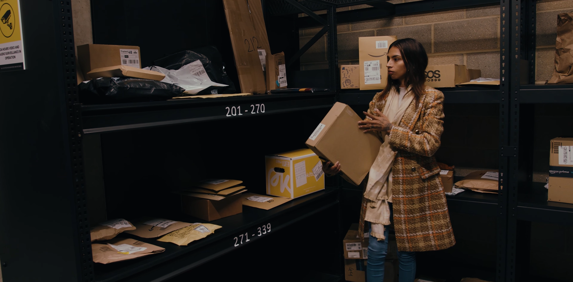 Women checking parcels in a store room